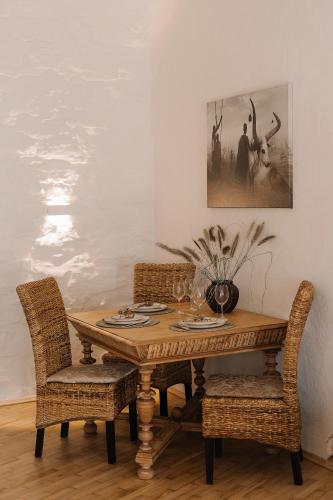 a dining room table with two chairs and a painting at n o c t u r n e in Kamianets-Podilskyi