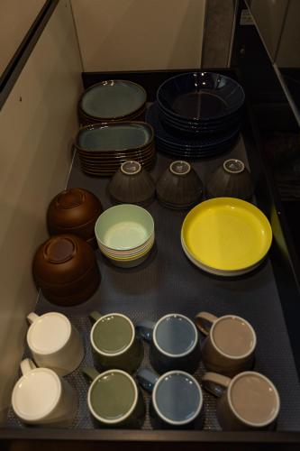 a drawer filled with different colored bowls and plates at GOAT BASE 仲間と楽しく過ごせる貸切宿 stay in Nagano