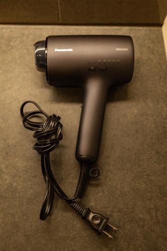 a hair dryer with a wire hooked up to it at GOAT BASE 仲間と楽しく過ごせる貸切宿 stay in Nagano