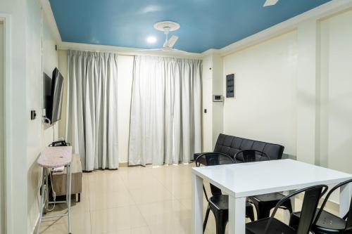 a room with a table and chairs and a couch at Air Residence 10978 in Hulhumale