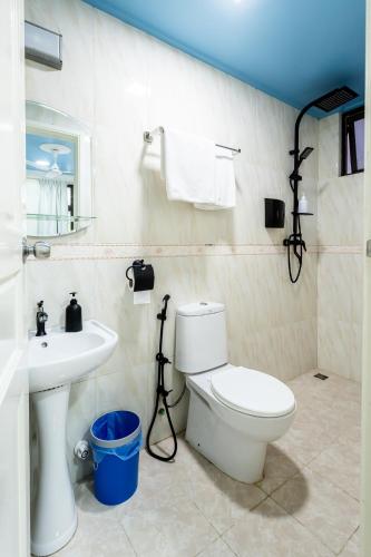 a bathroom with a white toilet and a sink at Air Residence 10978 in Hulhumale