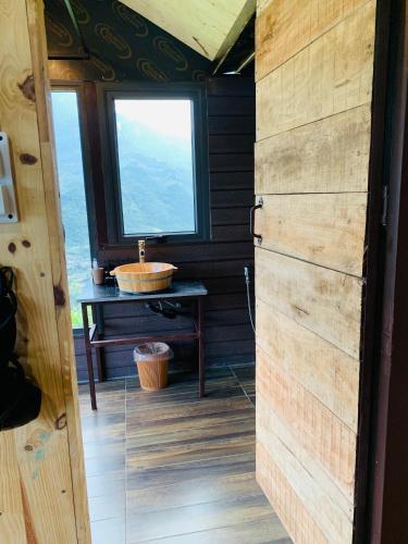 a bathroom with a sink and a window at Du peak home in Làng Cac