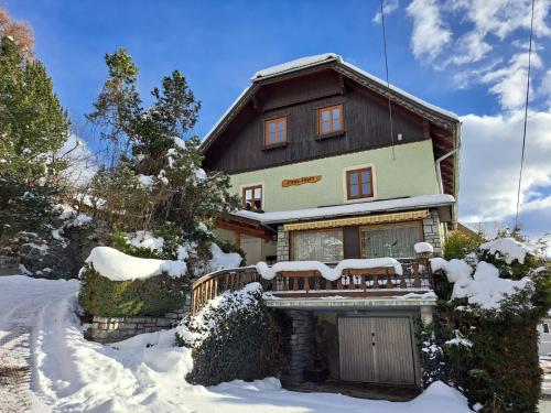 a house is covered in snow with snow at Appartement Bergliebe in Mauterndorf