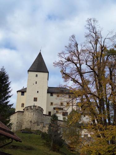 a large castle with a tower on top of it at Appartement Bergliebe in Mauterndorf