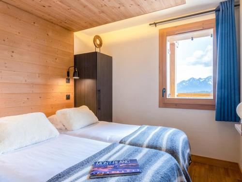 a bedroom with two beds and a window with mountains at Appartement de standing 4 pièces, SPA, parking, Les Saisies - FR-1-810-10 in Les Saisies