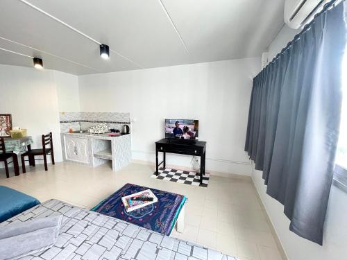 a living room with a bed and a table at Lively Impact C3-C9 in Nonthaburi