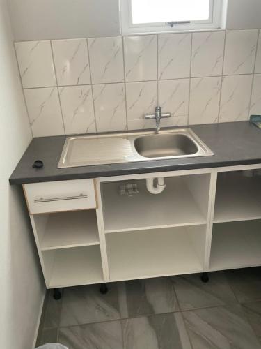 a kitchen counter with a sink and a window at Riverside Recreation Lodge in Katima Mulilo