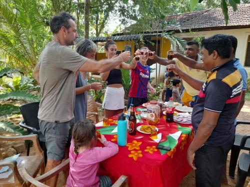 a group of people standing around a table at Sigiri Neo Homestay in Sigiriya