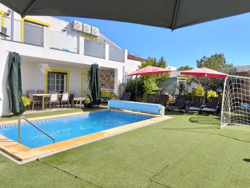 a swimming pool in the yard of a house at Suite Room Sofia's Happy House - Almodôvar Ourique Room 1 in Aldeia dos Fernandes