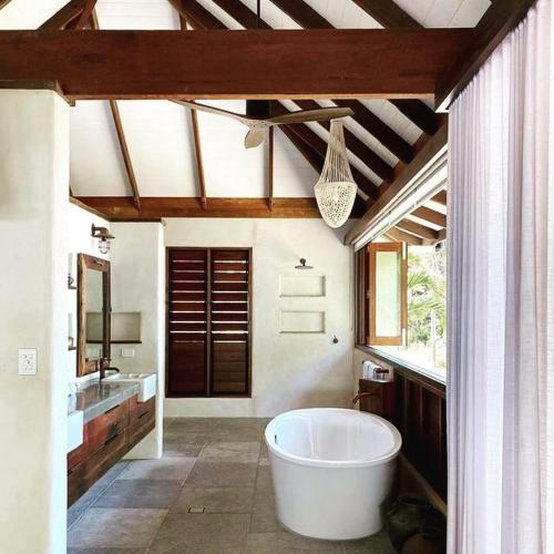 a large bathroom with a large tub and a sink at Spice At Oak Absolute Beachfront with Private Pool Near Port Douglas in Oak Beach
