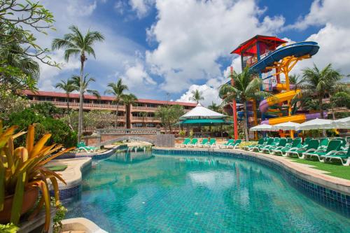 a pool at a resort with a water slide at Phuket Orchid Resort and Spa in Karon Beach