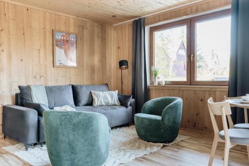 a living room with a couch and two chairs at Apres Ski Bachleda - LoftAffair Collection in Zakopane