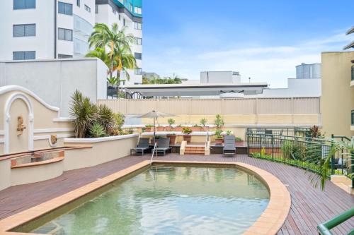 a swimming pool on the roof of a building at Stylish CBD retreat - 8 Il Palazzo in Cairns