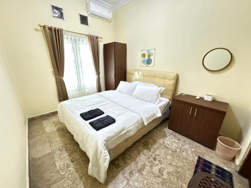 Ένα ή περισσότερα κρεβάτια σε δωμάτιο στο GBR B3 Homestay Jogja