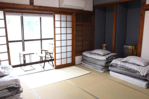 a room with two beds and a large window at Hotel Relation in 門司港 in Kitakyushu
