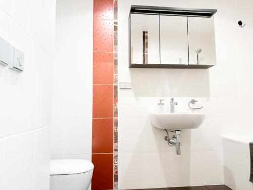 a bathroom with a toilet and a sink at Elite centre, free parking, ultra-desirable 1 of 1, lux view in Rīga