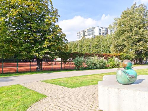 a statue of a frog sitting on a table in a park at Elite centre, free parking, ultra-desirable 1 of 1, lux view in Rīga