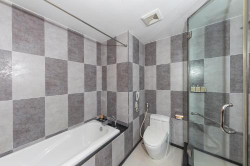 a bathroom with a tub and a toilet and a shower at Romance Hotel in Hue