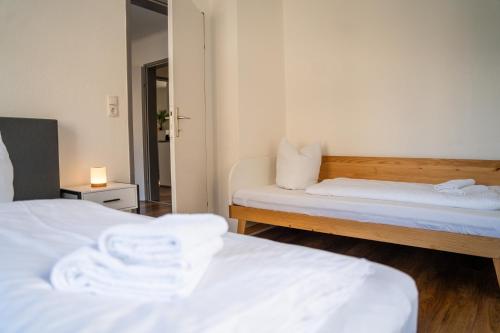 a room with two beds and a mirror at homy Lakeside Symphony in Bregenz am Bodensee in Bregenz