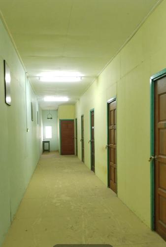 an empty hallway with doors and a long corridor at Ada D'Stay in Kota Bharu