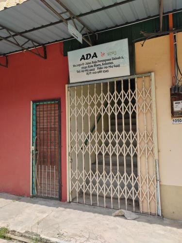 a gate in front of a red building with a sign at Ada D'Stay in Kota Bharu