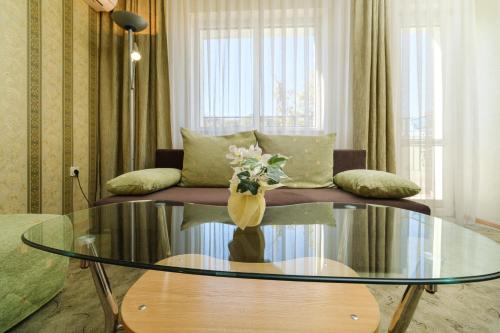 a living room with a couch and a glass table at Noviz Hotel in Plovdiv