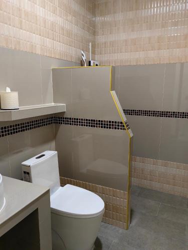 a bathroom with a white toilet and a sink at Kiree River Hotel โรงแรมคิรีริเวอร์ in Ban Thong Pha Phum