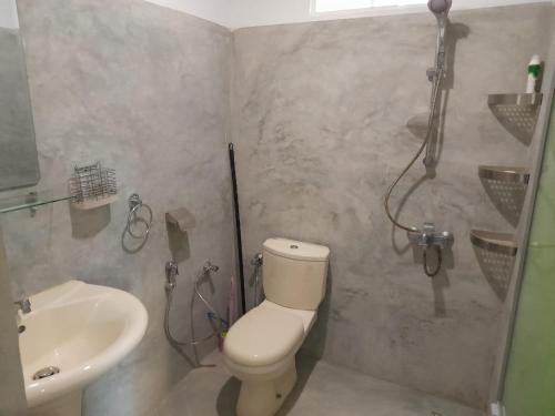 a bathroom with a shower and a toilet and a sink at Aruna Villa in Unawatuna