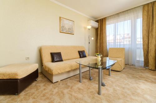 a living room with a couch and a glass table at Noviz Hotel in Plovdiv