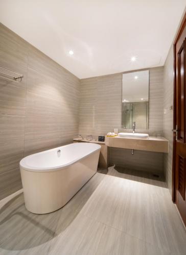 a large bathroom with a tub and a sink at Green Beach Hotel Nha Trang in Nha Trang