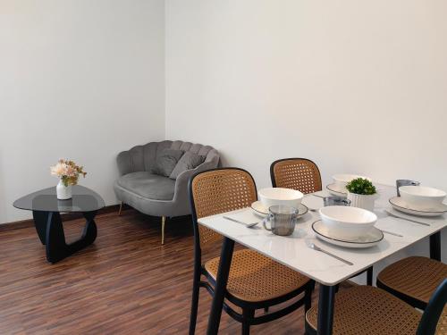 a dining room with a table and chairs and a couch at Near Airport K Avenue Family Room in Donggongon