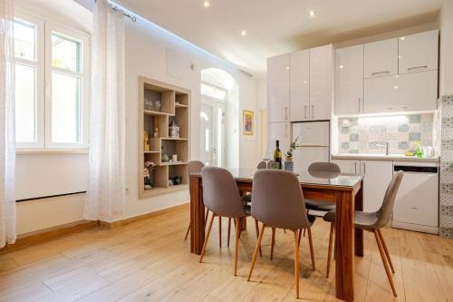 a kitchen and dining room with a table and chairs at Apartment Bacvice in Split