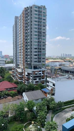 a large tall building in a city with buildings at Tranquil Urban Retreat at Cheangwattana in Pak Kret
