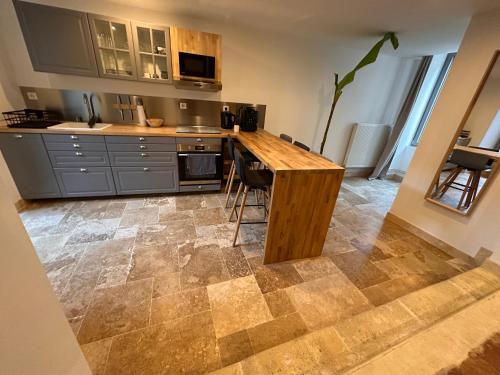 a kitchen with a wooden counter in a room at Au Petit Langres Logement Centre-Ville in Langres