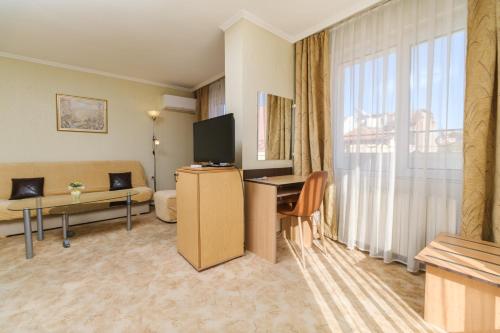 a hotel room with a large window and a living room at Noviz Hotel in Plovdiv