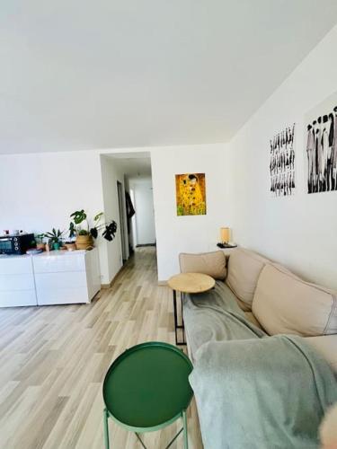 a living room with a couch and a table at Charming studio Versailles, close to Paris in Versailles
