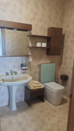 a bathroom with a sink and a toilet at Casa Seme di Faggio in Miasino