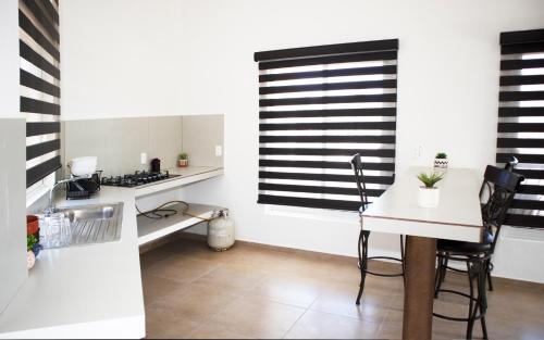 a kitchen with a table and chairs and a window at Hotel Larú spa resort in La Palma