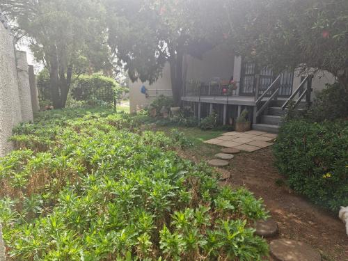 a house with a yard with plants and a walkway at Epicure Home Guesthouse in Heidelberg