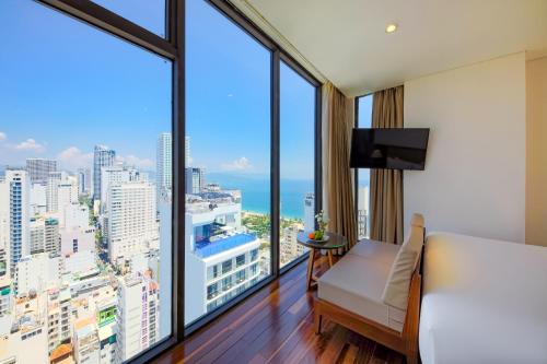 a hotel room with a view of the city at Green Beach Hotel Nha Trang in Nha Trang