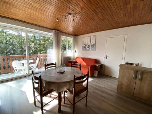 un salon avec une table, des chaises et un canapé dans l'établissement Résidence Le Midi - Super Studio calme exposé SUD quartier Venosc MAE-5341, à Vénosc