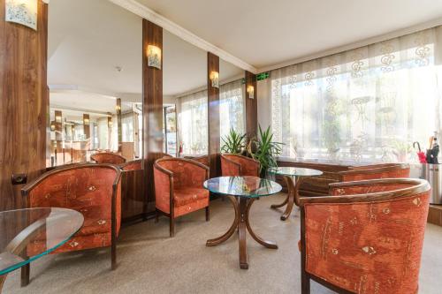 a restaurant with tables and chairs and a window at Noviz Hotel in Plovdiv