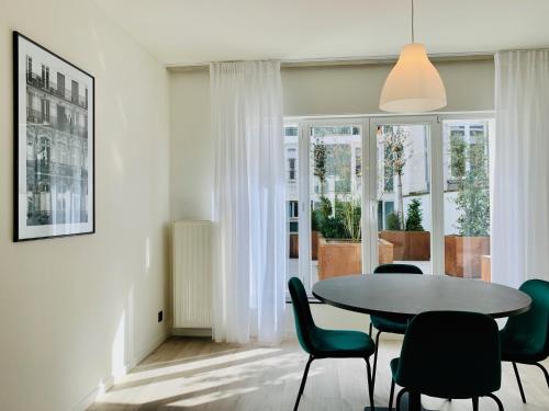 a dining room with a table and chairs at Belfort Shortstay in Ghent