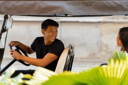 a man and a woman sitting in a vehicle at Further Hotel in Canggu