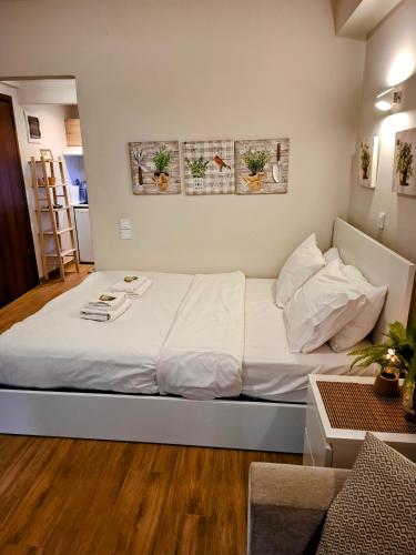 a bedroom with a large bed with white sheets at Studio Posh with garden in Kolonaki in Athens