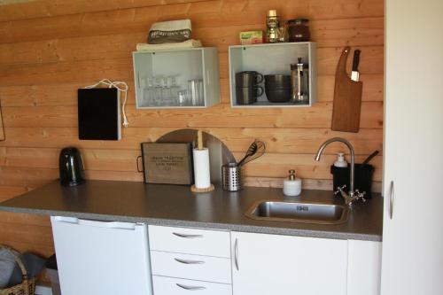 a kitchen with a sink and a counter top at Enghytten in Brønderslev