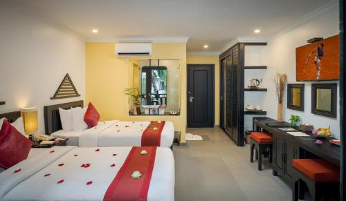 a hotel room with two beds and a bathroom at Khmer Mansion Boutique Hotel in Siem Reap