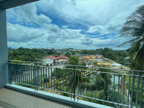 a balcony with a view of a city at Lamoon Trang in Ban Phlu Phli