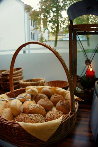 a basket of bagels and other pastries on a table at Schillers Hotel & Café - GARNI - in Lüdenscheid