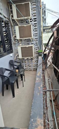 a room with two benches and a table on a building at Mekong Riverside in Vientiane